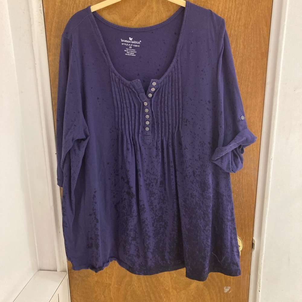 Woman within navy blue top Henley style with pin-tuck